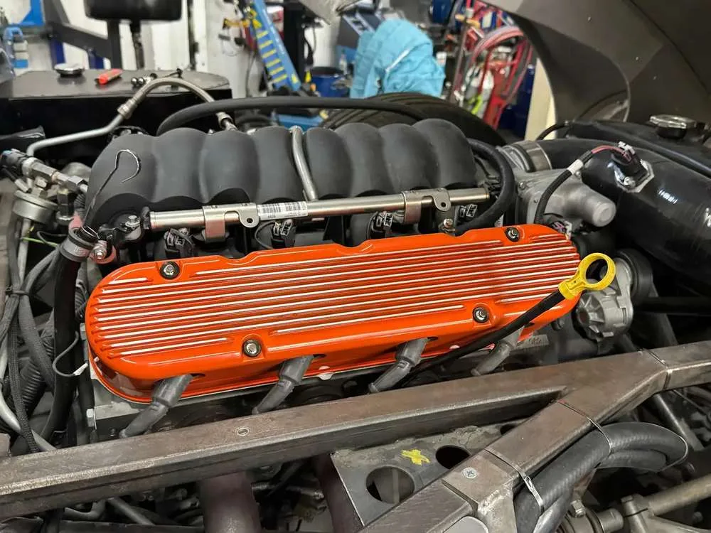 Hand-finished V8 with fluted valve covers in signal orange